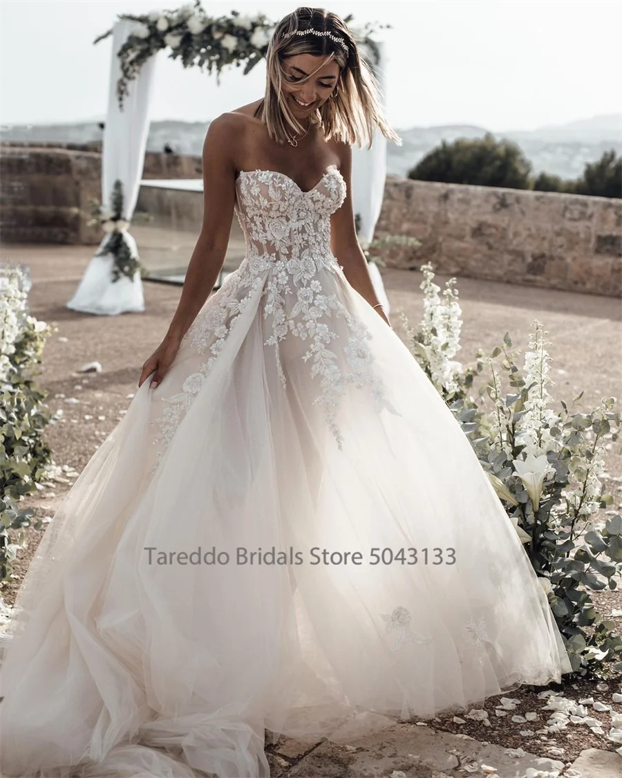 Customized Strapless Wedding Dress Featuring Stunning Crystals Lace Appliques and Flowy Silhouette Bridal Dress The Clothing Company Sydney
